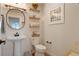 Charming powder room features a pedestal sink, decorative mirror and fixtures at 37625 Pheasant Run, Elizabeth, CO 80107