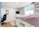 Bedroom features platform bed with built-in storage, TV, and a large window at 37625 Pheasant Run, Elizabeth, CO 80107