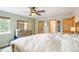 Spacious bedroom with a ceiling fan, ensuite bathroom, and a dresser with large mirror at 37625 Pheasant Run, Elizabeth, CO 80107