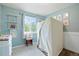 Bright bedroom with shelves, wainscotting, and a large window with natural light at 37625 Pheasant Run, Elizabeth, CO 80107