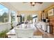Bright dining room featuring wood table, wood-burning stove, and large windows with backyard views at 37625 Pheasant Run, Elizabeth, CO 80107