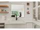 Farmhouse sink with subway tile backsplash and open shelving brings charm to this space at 37625 Pheasant Run, Elizabeth, CO 80107