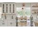 Bright and airy kitchen with open shelving, white cabinets, and a dining area view at 37625 Pheasant Run, Elizabeth, CO 80107