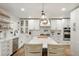Modern kitchen with stainless steel appliances, center island, and white subway tile backsplash at 37625 Pheasant Run, Elizabeth, CO 80107