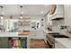 Well-lit kitchen with white cabinetry, floating shelves, and stainless steel appliances at 37625 Pheasant Run, Elizabeth, CO 80107