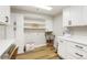 Well-equipped laundry room with modern cabinets, countertop space, and stainless steel sink at 37625 Pheasant Run, Elizabeth, CO 80107