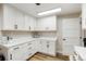 Bright laundry room featuring white cabinets, countertop space, and natural light at 37625 Pheasant Run, Elizabeth, CO 80107