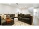 Bright living room featuring a plush sectional sofa, area rug, and stairs at 37625 Pheasant Run, Elizabeth, CO 80107