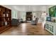 Open concept living room showcases hardwood floors, a stone fireplace, and comfortable seating at 37625 Pheasant Run, Elizabeth, CO 80107