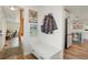 Mudroom features a bench, coat hooks, and view into open kitchen space at 37625 Pheasant Run, Elizabeth, CO 80107