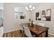 Cozy dining area with stylish lighting and views into the kitchen at 9733 E Carolina Pl, Aurora, CO 80247