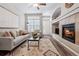 Comfortable living room featuring a cozy fireplace and neutral decor at 9733 E Carolina Pl, Aurora, CO 80247