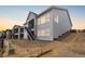 Exterior view of multi-level townhome featuring patios and staircases at 7392 Timberstone St, Castle Pines, CO 80108