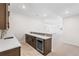 Basement bar area with a wine cooler, cabinets, counter, and adjacent open space at 7392 Timberstone St, Castle Pines, CO 80108
