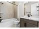 Stylish bathroom features tub and shower combo, modern vanity and black fixtures at 7392 Timberstone St, Castle Pines, CO 80108