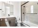 Modern bathroom featuring black fixtures, shower with glass door, white walls, and tile at 7392 Timberstone St, Castle Pines, CO 80108