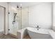 This primary bathroom features a soaking tub, walk-in shower with bench, and double sink vanity at 7392 Timberstone St, Castle Pines, CO 80108