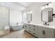 This bathroom features dual sinks, modern fixtures, a soaking tub and a separate shower at 7392 Timberstone St, Castle Pines, CO 80108