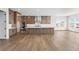 Spacious kitchen with a large island, wooden cabinets, and stainless steel appliances at 7392 Timberstone St, Castle Pines, CO 80108