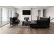 Modern living room with a fireplace, hardwood floors, and stylish furniture at 7392 Timberstone St, Castle Pines, CO 80108