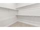 This walk-in closet features metal shelving, white walls, and carpeted flooring at 7392 Timberstone St, Castle Pines, CO 80108
