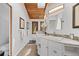 Bright bathroom with dual sinks, wood ceiling and ample vanity space at 8821 Blue Creek Rd, Evergreen, CO 80439