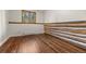 Bedroom with hardwood floors and a log wall offers a cozy and rustic aesthetic at 8821 Blue Creek Rd, Evergreen, CO 80439