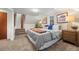 Bedroom with carpet flooring, a window, furnishings and stairs to another level at 8821 Blue Creek Rd, Evergreen, CO 80439