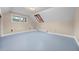 Attic bedroom with light blue painted floors, a window, and ample natural light at 8821 Blue Creek Rd, Evergreen, CO 80439