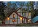 Two-story home featuring unique design with timber accents surrounded by lush trees at 8821 Blue Creek Rd, Evergreen, CO 80439