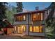 Charming exterior showcasing a unique design with stone accents and large windows at 8821 Blue Creek Rd, Evergreen, CO 80439