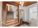 Inviting home foyer featuring wood ceilings, tiled floors, and stairs to the upper level at 8821 Blue Creek Rd, Evergreen, CO 80439