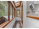Sunlit hallway features large windows, skylight, and views of surrounding greenery, creating a bright and inviting space at 8821 Blue Creek Rd, Evergreen, CO 80439