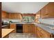 Well-lit kitchen with wood cabinets, ample counter space, and a view of the outdoors at 8821 Blue Creek Rd, Evergreen, CO 80439