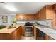 Charming kitchen with wood cabinets, stainless steel appliances, and ample counter space at 8821 Blue Creek Rd, Evergreen, CO 80439