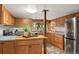 Spacious kitchen with wood cabinets, stainless steel appliances, and natural light at 8821 Blue Creek Rd, Evergreen, CO 80439