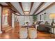 Spacious living room with exposed wood beams, offering a rustic and inviting atmosphere at 8821 Blue Creek Rd, Evergreen, CO 80439