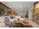 Spacious living area with stone accent wall, hardwood floors and view to the backyard at 8821 Blue Creek Rd, Evergreen, CO 80439
