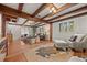 Living area featuring exposed beams, hardwood floors, and a cozy seating arrangement at 8821 Blue Creek Rd, Evergreen, CO 80439