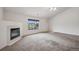 Cozy living room area featuring a fireplace and a large window with outside views at 18080 Becket Dr, Parker, CO 80134