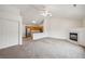 Spacious living room with vaulted ceilings, fireplace, and easy access to the kitchen area at 18080 Becket Dr, Parker, CO 80134