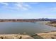 Aerial view of a lake with the city skyline in the background and foliage foreground at 2524 Zenobia St, Denver, CO 80212