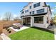 A modern backyard with a patio set on concrete pad and healthy green lawn and modern fence at 2524 Zenobia St, Denver, CO 80212