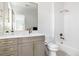 Modern bathroom featuring gold fixtures, a vanity and a combined tub and shower at 2524 Zenobia St, Denver, CO 80212