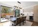 Open concept dining room with access to the patio, modern light fixture, and bar area at 2524 Zenobia St, Denver, CO 80212