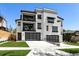 Modern white home with black trim, balconies, and attached garages at 2524 Zenobia St, Denver, CO 80212