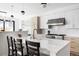 Bright kitchen featuring an island with seating, modern lighting, and updated appliances at 2524 Zenobia St, Denver, CO 80212