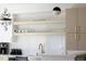 Bright kitchen featuring open shelving, stylish hardware, and modern appliances at 2524 Zenobia St, Denver, CO 80212
