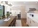 Open kitchen with stainless steel appliances, sleek cabinets and hardwood floors at 2524 Zenobia St, Denver, CO 80212
