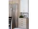 Modern kitchen with stainless steel refrigerator and custom cabinetry with gold hardware at 2524 Zenobia St, Denver, CO 80212